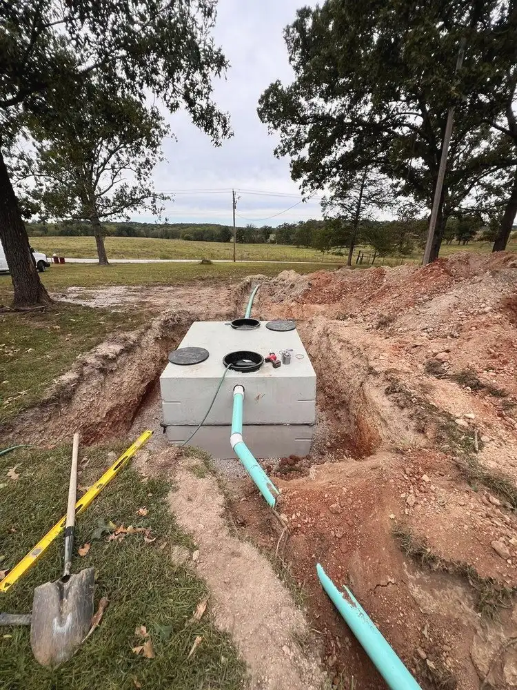 New septic tank set in the ground and tied in