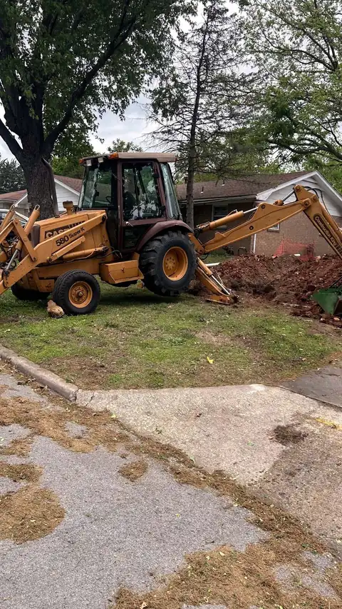 Messina backhoe trenching water and sewer lines on a new construction site